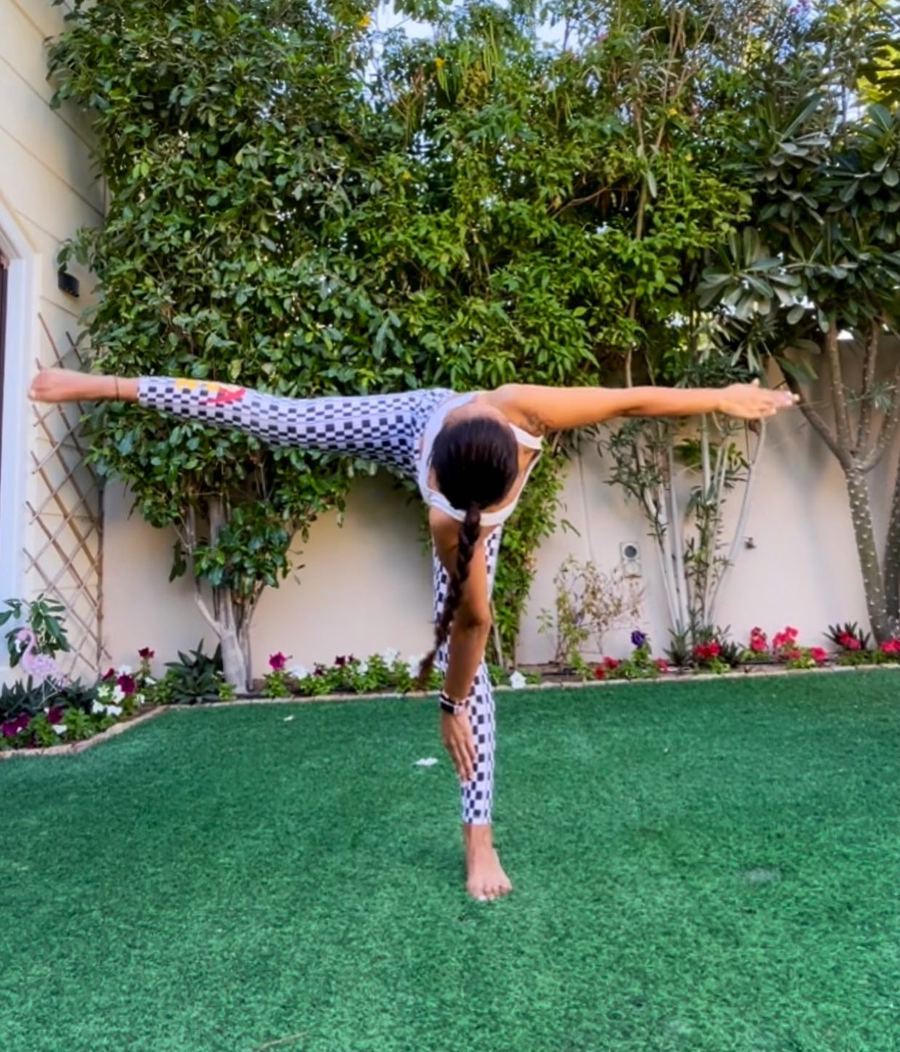 Aastha Chopra in Revolved forward fold (Parivrtta Uttanasana), Garden, Dubai, January 2021