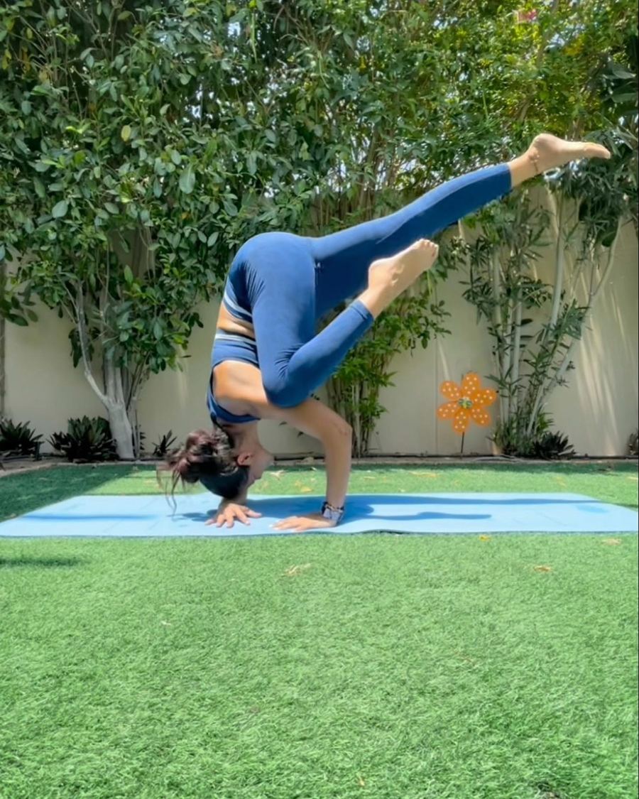 Aastha Chopra in Forearm balance, bent legs (Pincha Mayurasana variation), Garden, Dubai, April 2021