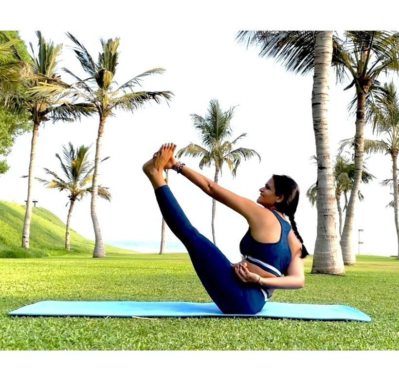 Aastha Chopra in Heron (Krounchasana), Palm-lined lawn, Dubai, August 2021