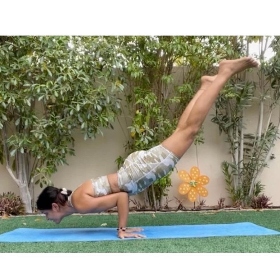 Aastha Chopra in Peacock, legs lifted (Mayurasana variation), Garden, Dubai, May 2022