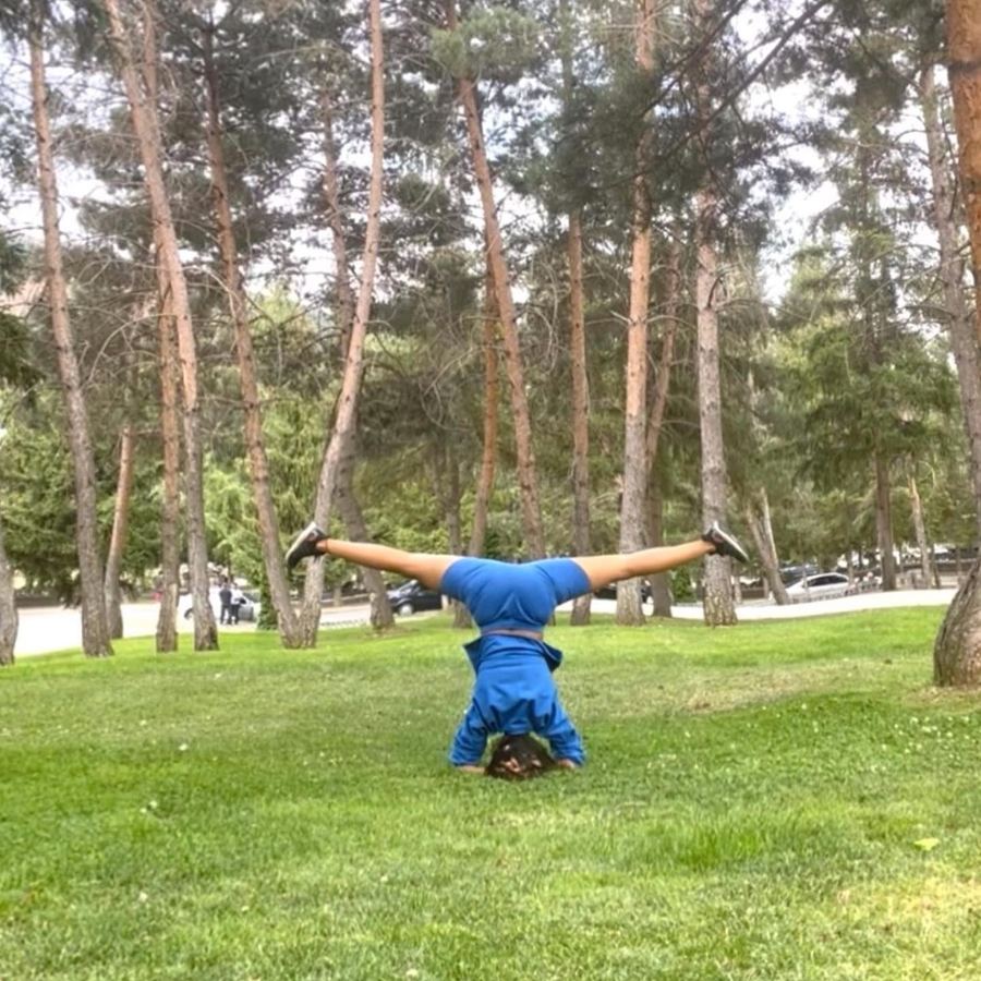 Aastha Chopra in Straddle headstand (Sirsasana, wide legs), A pine forest, October 2022