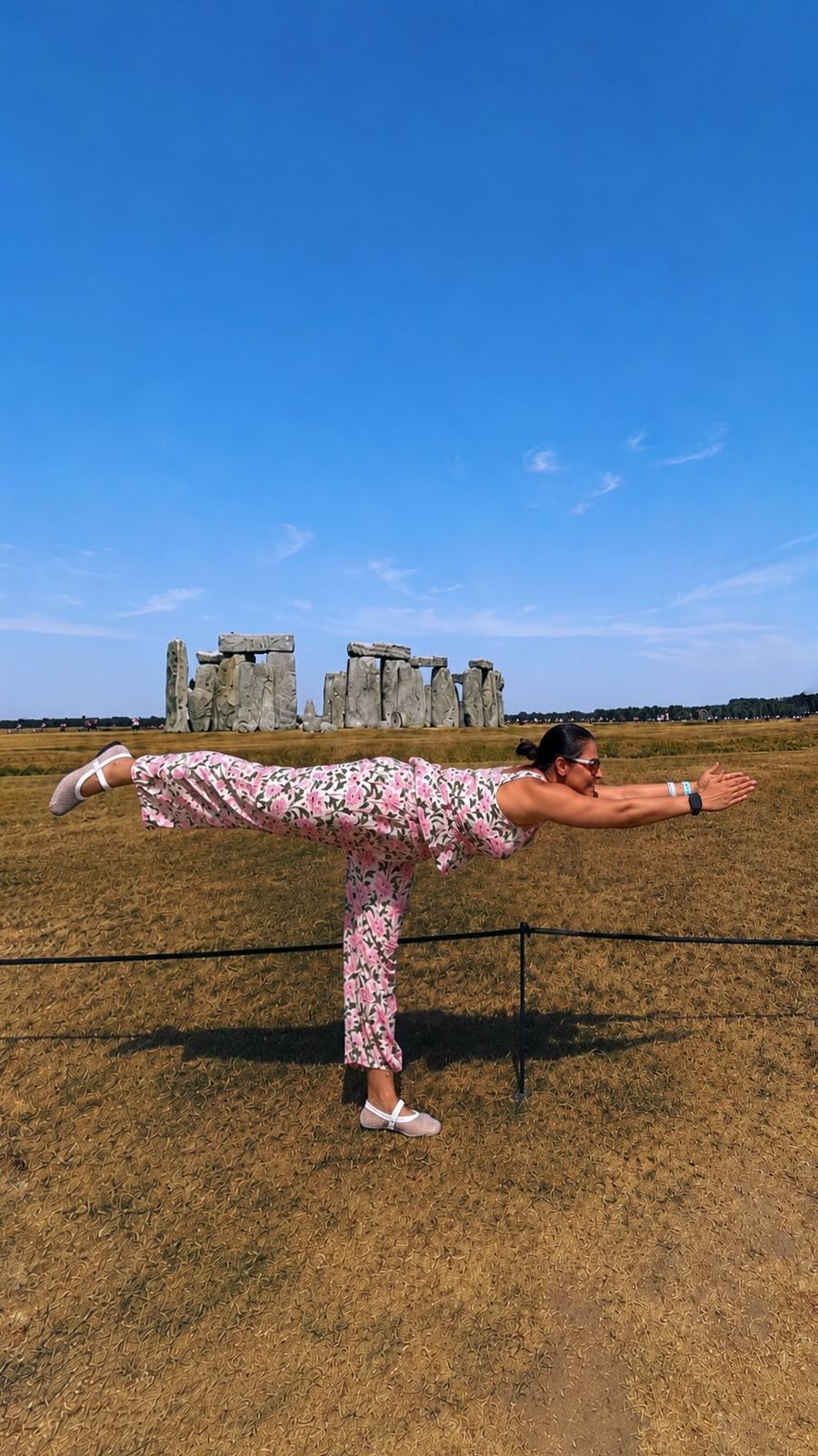 Aastha Chopra in Warrior three at Stonehenge (Virabhadrasana III), Stonehenge, England, July 2026